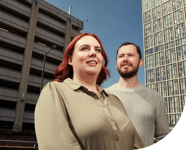 women and man standing in front of a building