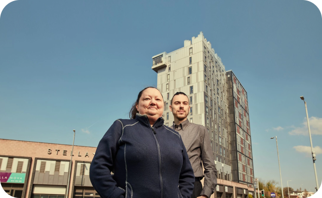 man and woman standing in front of building